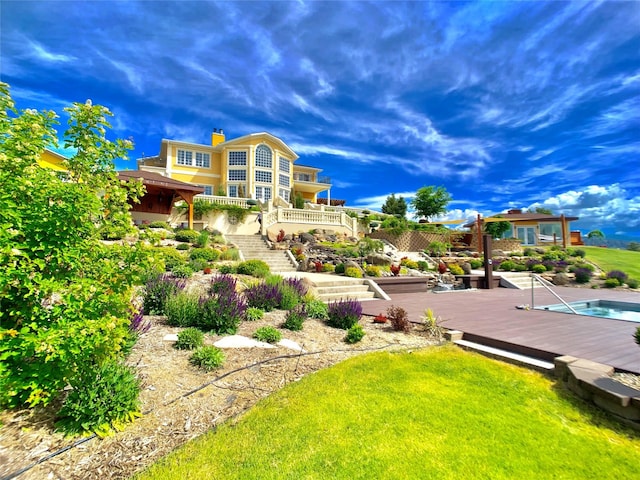 view of home's community featuring a yard and a deck