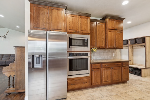 kitchen featuring stainless steel appliances and tasteful backsplash