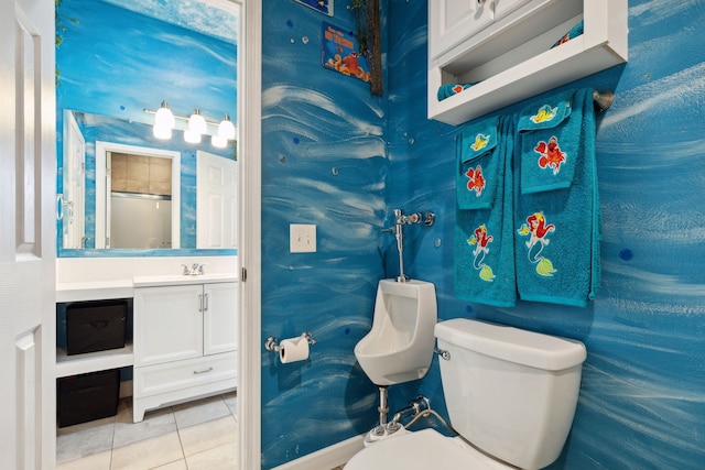 bathroom with tile patterned flooring, vanity, and toilet