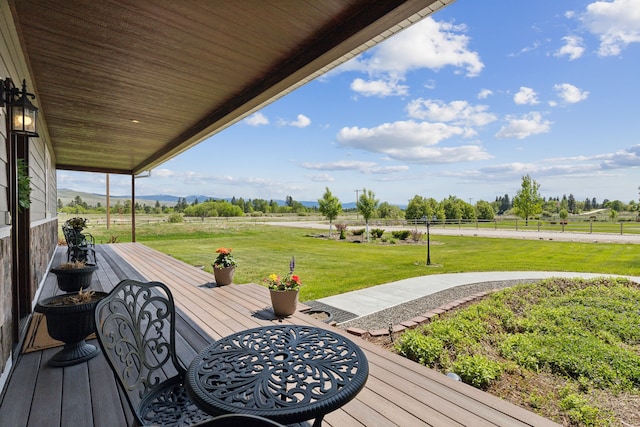 deck featuring a rural view and a yard