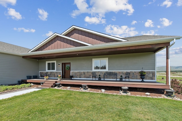 view of front of property with covered porch and a front yard