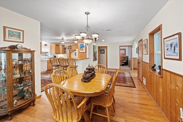 dining area with a notable chandelier and light wood-type flooring