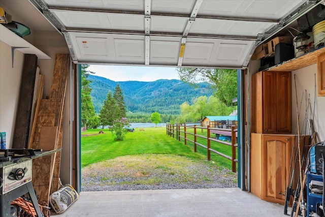 garage featuring a mountain view and a yard