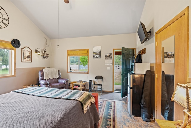 tiled bedroom with ceiling fan and vaulted ceiling