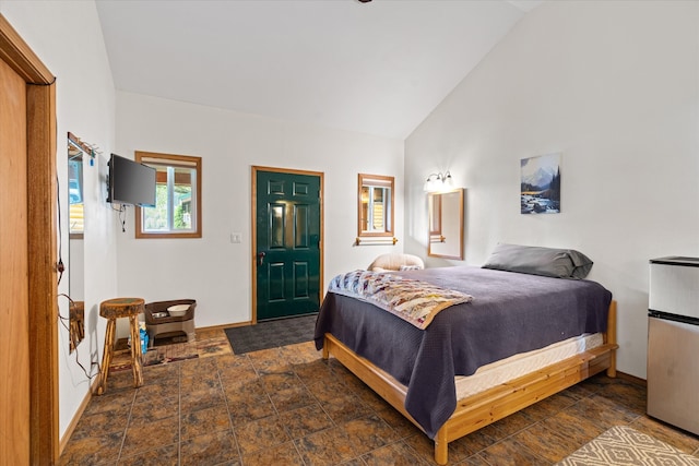 tiled bedroom featuring high vaulted ceiling