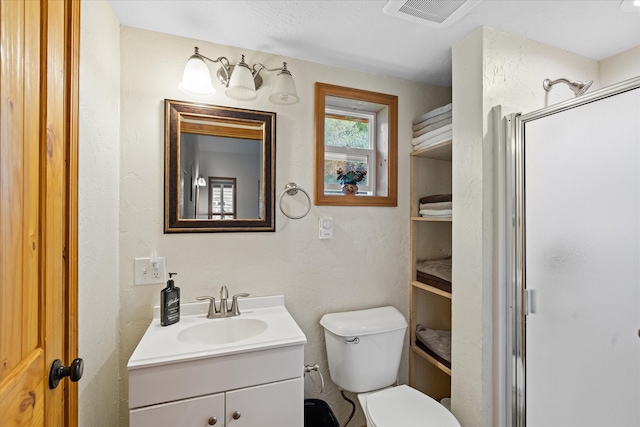 bathroom featuring toilet and vanity with extensive cabinet space