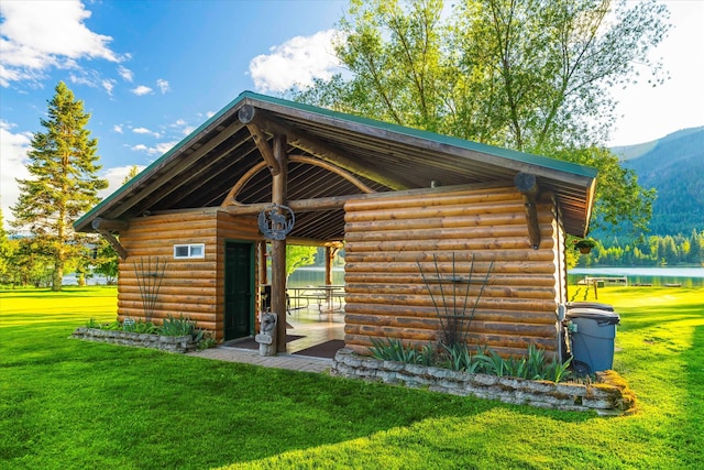 view of shed / structure featuring a water view and a lawn