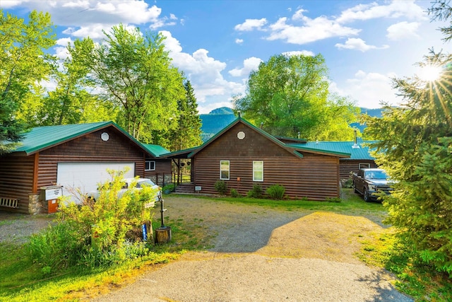 log-style house with a garage