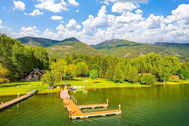 view of dock with a water and mountain view