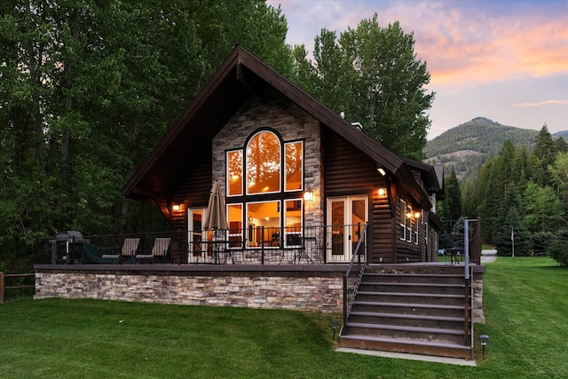 back house at dusk with a yard