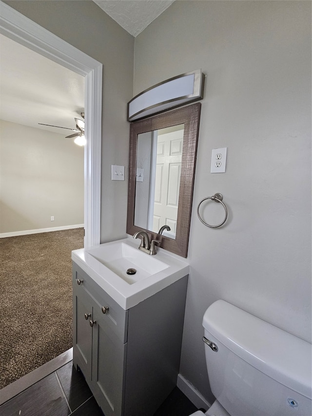 bathroom with tile floors, ceiling fan, oversized vanity, and toilet