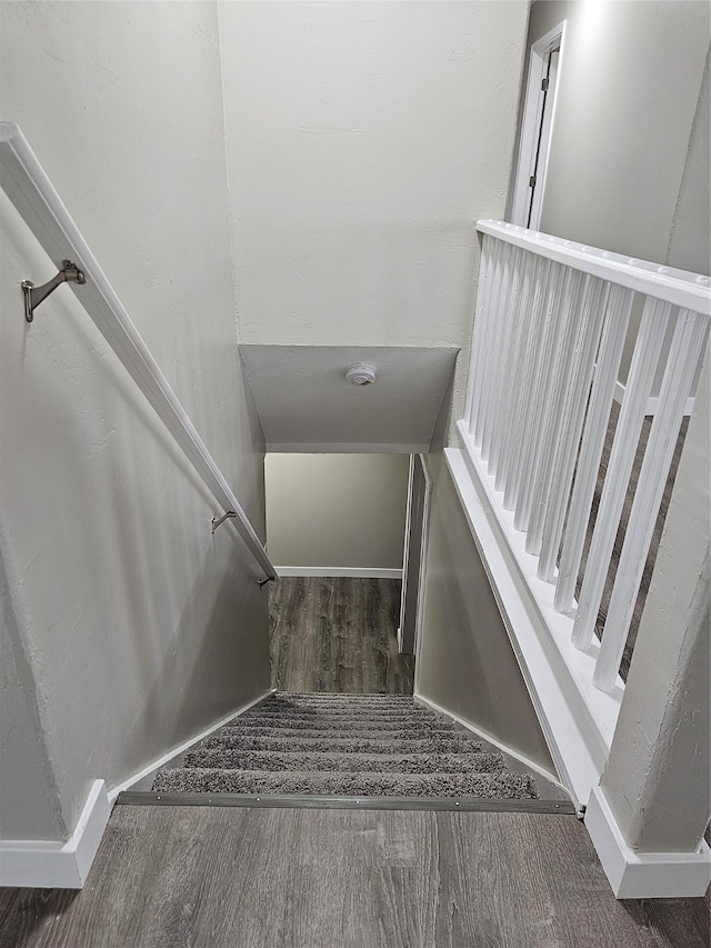 stairway featuring dark hardwood / wood-style flooring