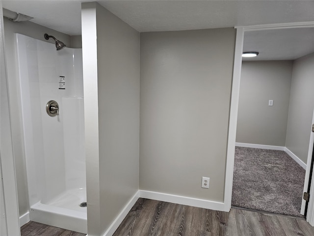 bathroom featuring hardwood / wood-style floors and a shower