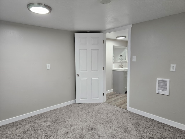 carpeted spare room with sink