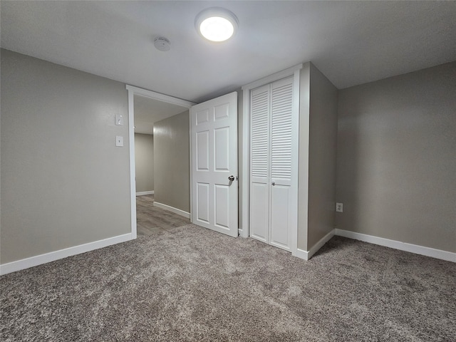 unfurnished bedroom with carpet flooring and a closet