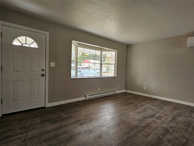 entryway with a wall mounted AC, a baseboard radiator, a textured ceiling, and dark hardwood / wood-style floors