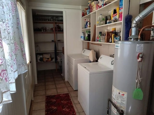 washroom with water heater, washing machine and dryer, and light tile patterned floors