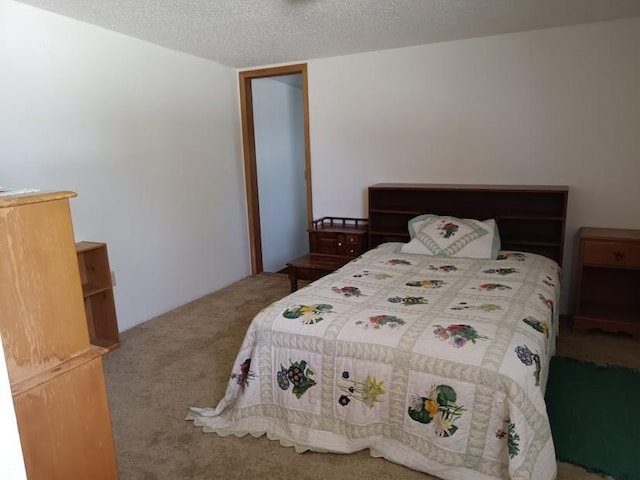 carpeted bedroom featuring a textured ceiling