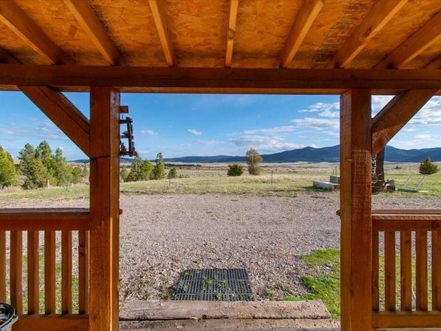 view of yard with a mountain view and a rural view