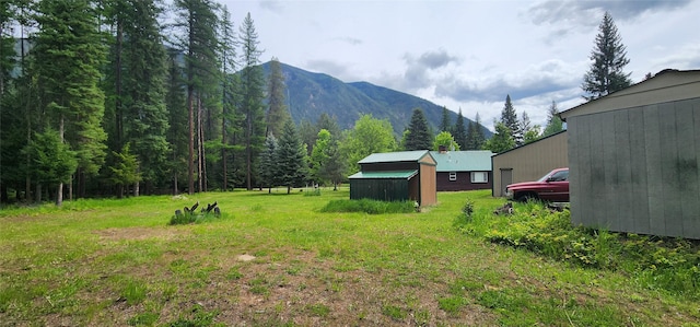 view of yard featuring an outbuilding and a mountain view