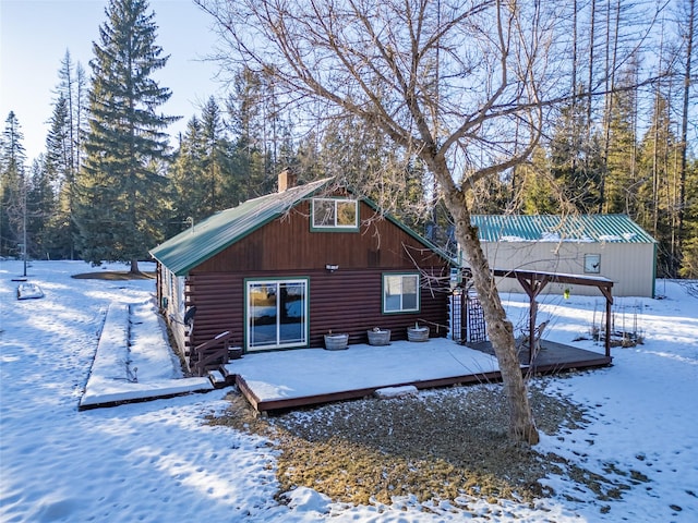 snow covered property with a deck