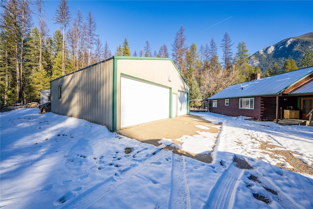 snow covered garage with a mountain view