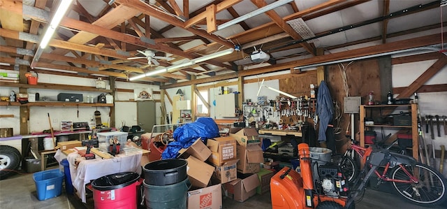 garage with a garage door opener and a workshop area