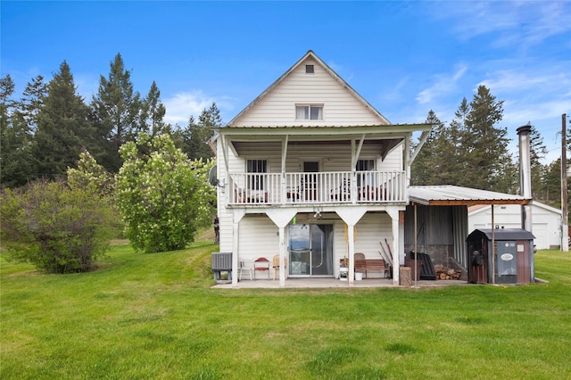 back of house featuring a lawn, central AC unit, a patio area, and an outdoor structure