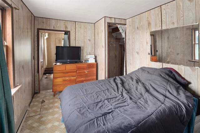 bedroom featuring wooden walls