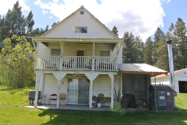 rear view of house with a yard and a patio