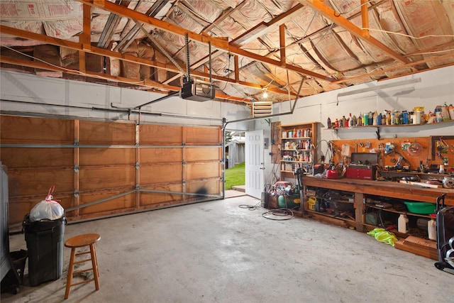 garage with a workshop area and a garage door opener