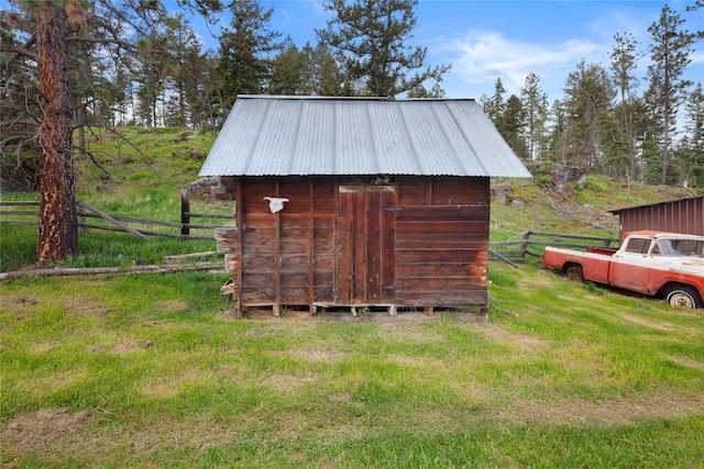 view of outdoor structure featuring a lawn