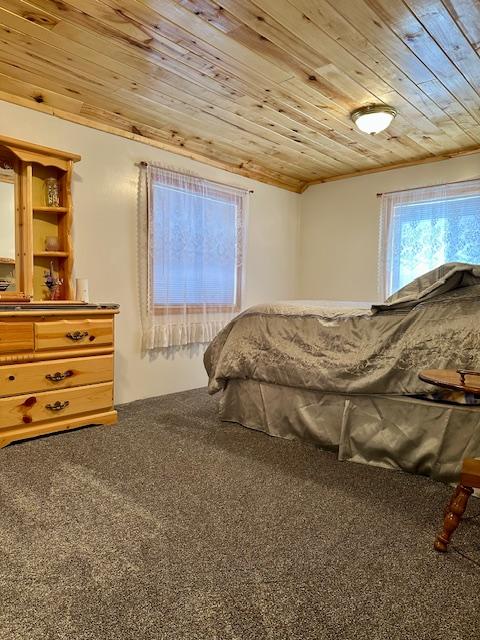 bedroom with carpet and wood ceiling