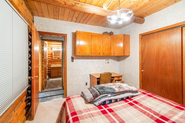 bedroom featuring beamed ceiling, wooden ceiling, and a closet