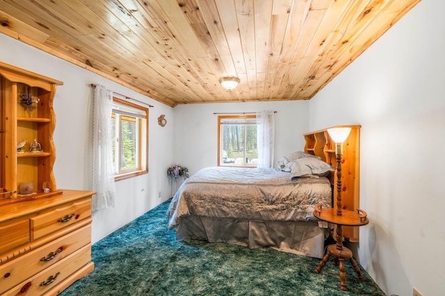 bedroom featuring multiple windows, carpet, and wood ceiling