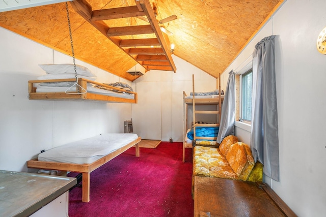 bedroom with vaulted ceiling and dark colored carpet