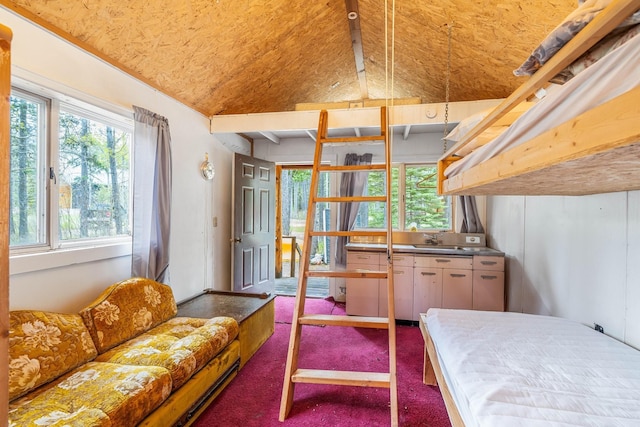 bedroom featuring sink, carpet floors, and lofted ceiling