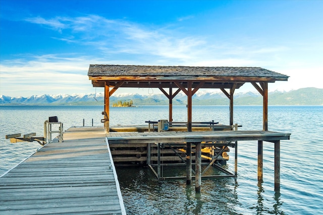 dock area featuring a water and mountain view