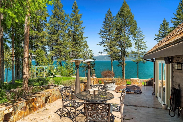 view of terrace with a water view