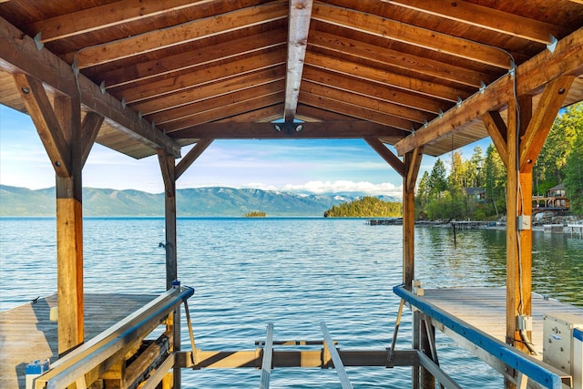 view of dock featuring a water and mountain view