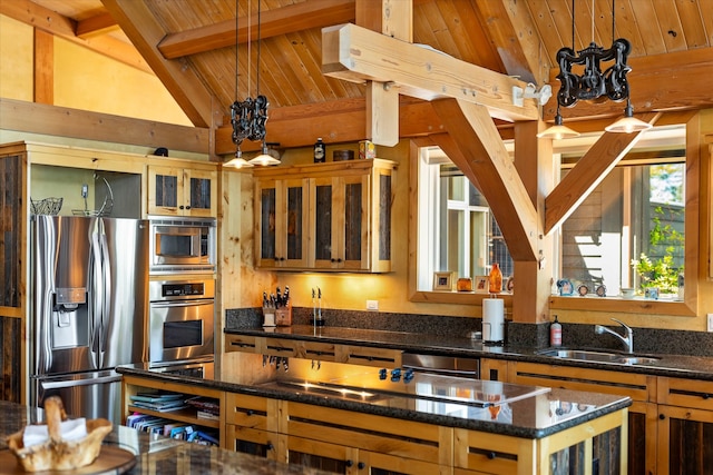 kitchen with vaulted ceiling with beams, appliances with stainless steel finishes, pendant lighting, sink, and wood ceiling