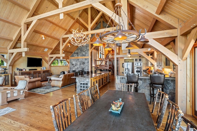 dining space with beam ceiling, wooden ceiling, a chandelier, and hardwood / wood-style floors