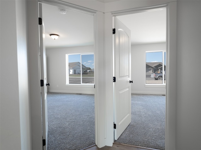 hallway featuring light colored carpet