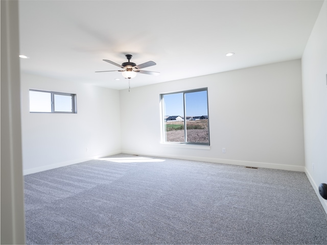 empty room with ceiling fan and carpet floors