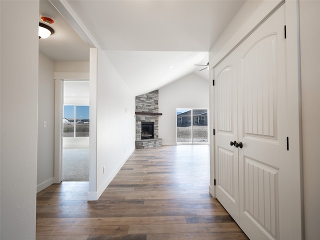 hallway with vaulted ceiling and dark wood-type flooring