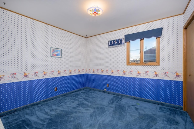 carpeted spare room with crown molding