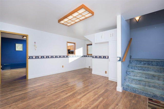 unfurnished living room with dark hardwood / wood-style flooring