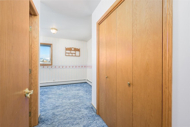 corridor featuring baseboard heating and light colored carpet