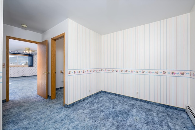 carpeted empty room with a baseboard heating unit