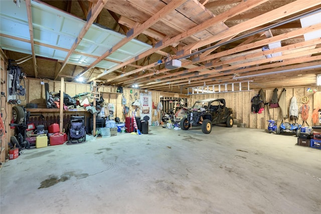 garage featuring a garage door opener and a workshop area